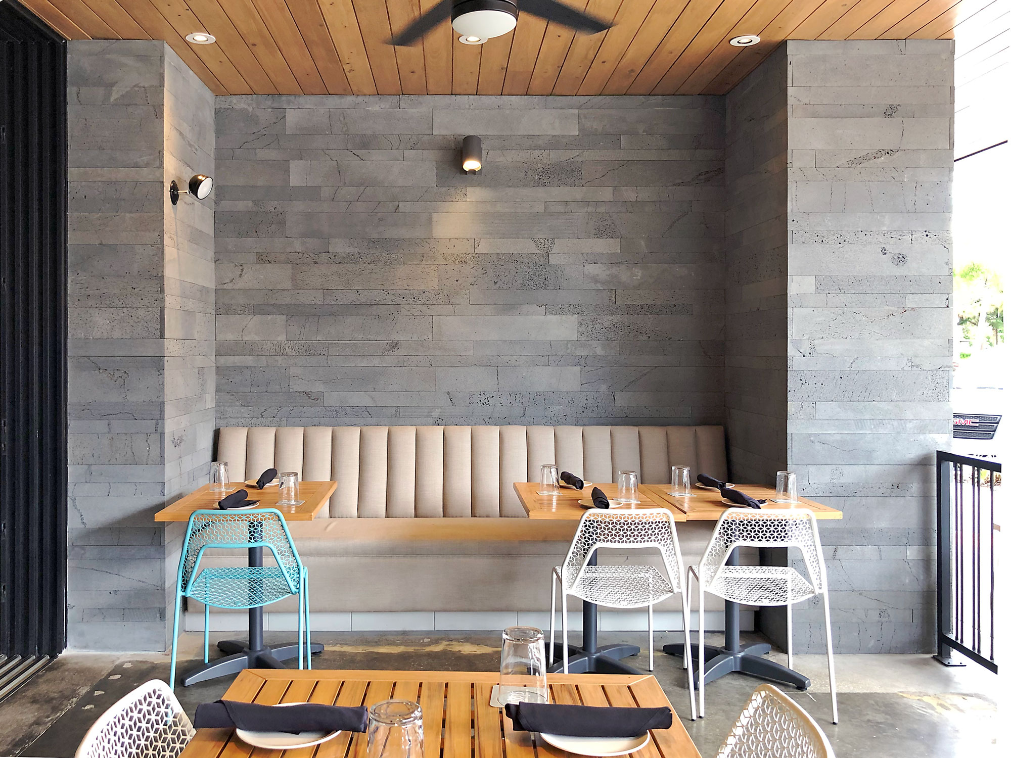 Norstone Planc large format tile in Platinum Lavastone surrounding a bench seat at a restaurant in Sarasota, FL